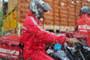 腰まで水につかった状態で冠水した道路を渡り料理を運ぶインドの配達員のど根性